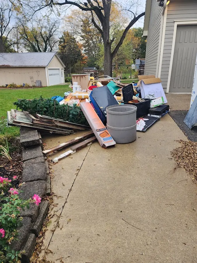 Dumpster being loaded with debris for 12 Yard Dumpster Rental in Pleasant Prairie